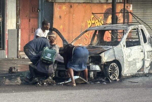 Homeless people stripping a burnt car in Durban CBD